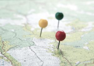 close up of three push pins on a map